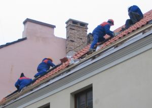 Will Renovating Help Your Property Sell construction workers on a roof